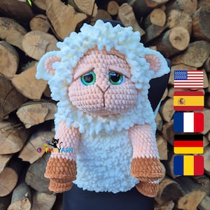 May include: A handmade crochet sheep doll with a sad expression. The sheep has a white fluffy head and body, pink face and ears, and brown hooves. The eyes are green. The doll is sitting on a black surface.