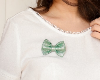 Iridescent green bow pin