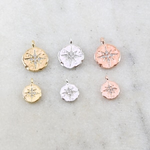 May include: Six small, round pendants with a starburst design in the center. The pendants are available in gold, silver, and rose gold.