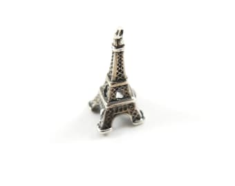 May include: A silver Eiffel Tower charm, a miniature replica of the iconic Parisian landmark.