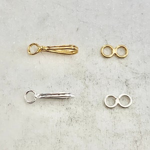 May include: Two sets of jewelry findings, one gold and one silver. Each set includes a pendant bail and a jump ring.