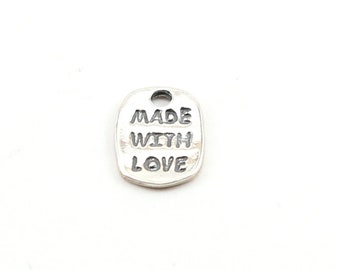 May include: Silver charm with the words "Made with Love" engraved on it.