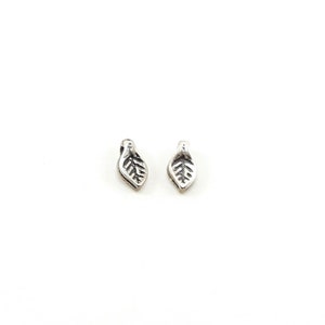 May include: A pair of silver leaf earrings. The leaves are detailed and have a delicate design.