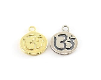 Round embossed ohm charm with loop in sterling silver and vermeil gold