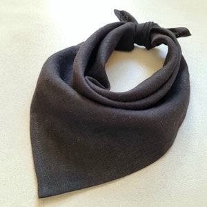 May include: A black bandana made of a soft, textured fabric. The bandana is folded into a triangle shape and tied at the top.