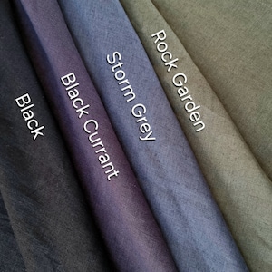 May include: Five fabric swatches in different shades of gray, black, and green. The swatches are labeled "Black", "Black Currant", "Storm Grey", "Rock Garden".