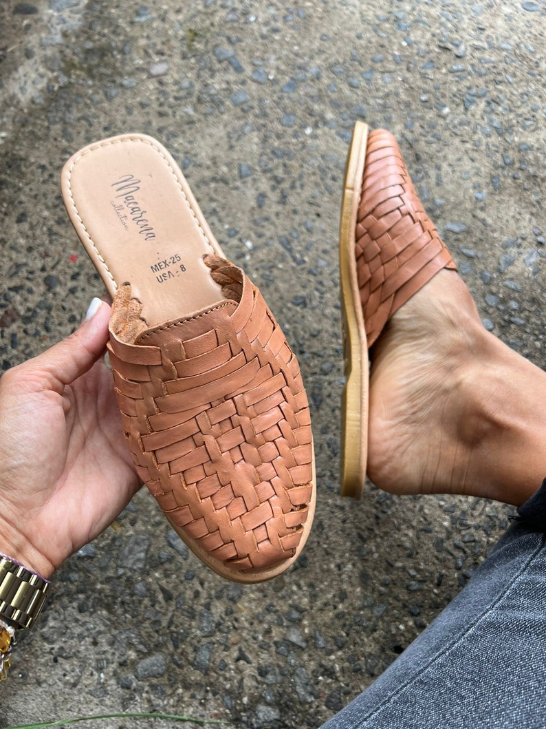 May include: Tan leather woven sandals with a woven design. The sandals have a label that reads "Macarena" and "MEX-25, USA-8".