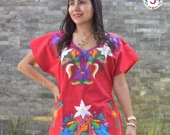 May include: A red embroidered cotton dress with colorful floral designs. The dress has a V-neckline and short sleeves.