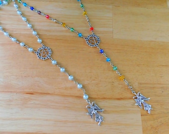 May include: Two silver necklaces with pentagram charms and angel wing pendants. One necklace has white beads and the other has multi-colored beads.