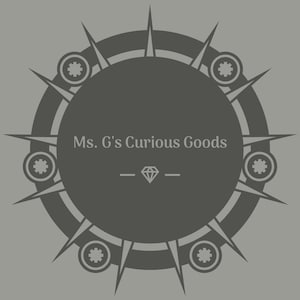 May include: A black and white circular design with a gray background. The design features a circle with spikes around the edge and smaller circles with a gear-like design inside. The text "Ms. G's Curious Goods" is written in the center of the circle, with a diamond symbol below it.