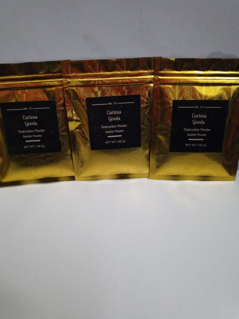 May include: Three gold foil pouches with black labels that read "Ms. G's Curious Goods Destruction Powder Satchet Powder NET WT. 1 OZ (28g)"
