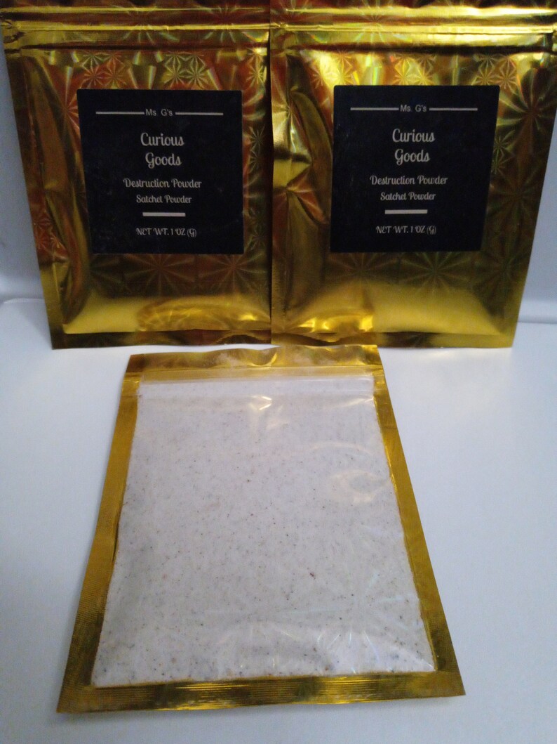 May include: Two gold foil pouches with black labels that read "Ms. G's Curious Goods Destruction Powder Satchel Powder NET WT. 1 OZ (28g)". A third pouch is open and shows a white powder inside.