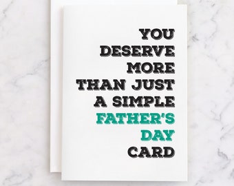 Może przedstawiać: Biała kartka na Dzień Ojca z napisem "YOU DESERVE MORE THAN JUST A SIMPLE FATHER'S DAY CARD" w czarnych i turkusowych literach. Karta jest pusta w środku i jest dostarczana z białą kopertą.