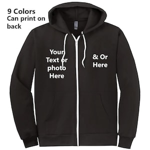 Puede incluir: Sudadera con capucha negra con cremallera y texto blanco que dice "Your Text or photo Here" en el lado izquierdo y "& Or Here" en el lado derecho.