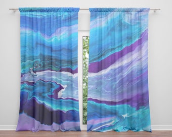 Può includere: Due tende da finestra con un vivace design astratto. Le tende presentano un motivo fluido di blu, viola e bianco, creando un effetto acquerello. Sono appese davanti a una finestra, con una vista sugli alberi.