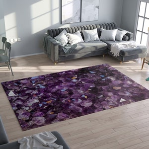 May include: A rectangular area rug with a vibrant amethyst crystal design. The rug features a gradient of purple hues, with geometric shapes and reflective surfaces. The rug is placed on a light wood floor in a living room setting.