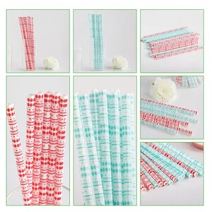May include: A bundle of red and blue paper straws with a snowflake and reindeer pattern. The straws are arranged in a vertical stack.