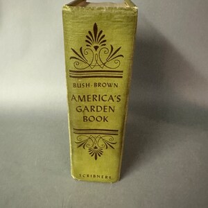 May include: A green book titled "America's Garden Book" by Bush-Brown. The book is published by Scribners.