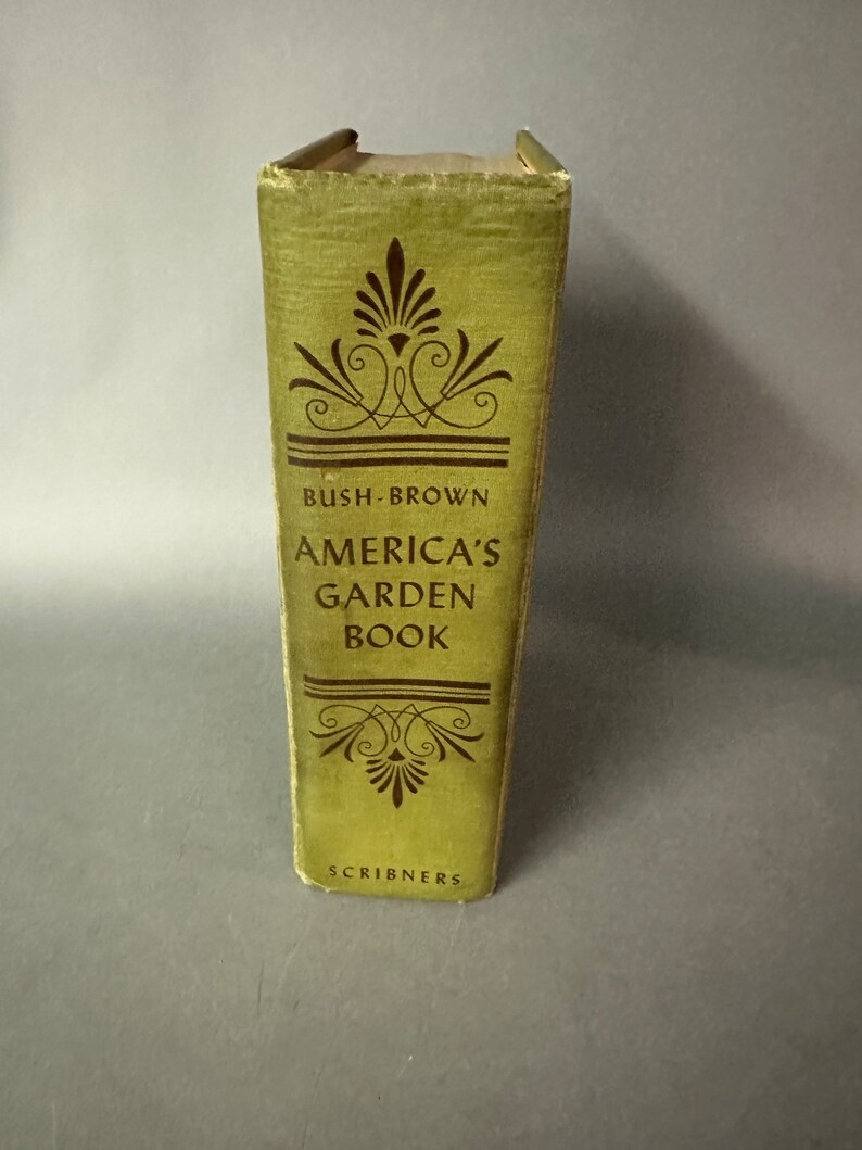 May include: A green book titled "America's Garden Book" by Bush-Brown. The book is published by Scribners.