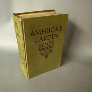 May include: A vintage green book titled "America's Garden Book" with gold lettering and a decorative design.