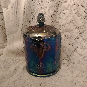 An octagon shape blue carnival glass candy dish and matching lid, by Indiana Glass with embossed grape clusters, vines and leaves.  Bowl 753