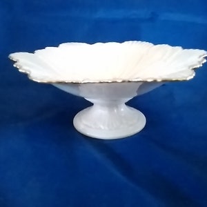 Lenox ivory scalloped porcelain decorative bowl with a leaf pattern on the bowl and base.  It has 24 karat gold trimmed rim.  Bowl 1098