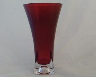 Large red FTD vase with a round rim and a clear square weighted base.  Vase 201