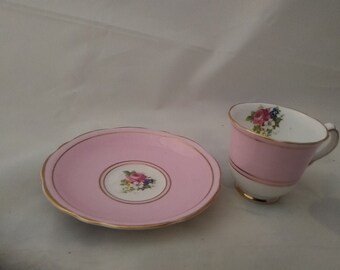 A Gladstone gold trimmed pink and floral demitasse cup and saucer. CS 23