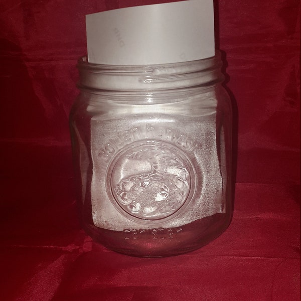 A Golden Harvest embossed glass canister with a fruit design. Misc 887