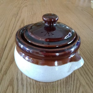 A tri colored stoneware 16 oz soup or bean crockpot beige, tan, and brown with its matching brown lid.  SW 235