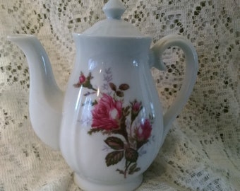 A 2.5 cup white porcelain pedestal tea pot with the Moss Rose pattern in gold trim, in great circa 1950 condition. CS 234