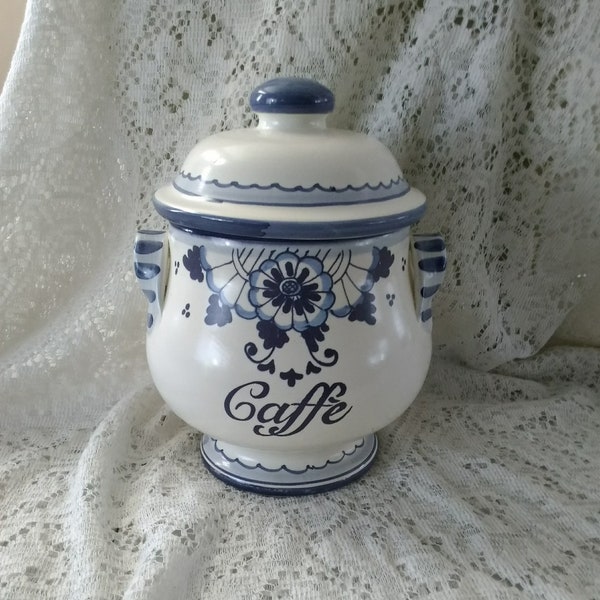 A white ceramic Ceramiche IL Ponte Caffe canister hand painted cobalt script and blue shade designs with matching gasketed lid.  Dish 1248