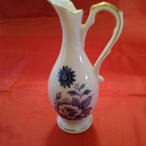 An Olimco white porcelain single bud vase in the form of a pitcher with cobalt blue flowers and gold trim from Japan  Vase 273