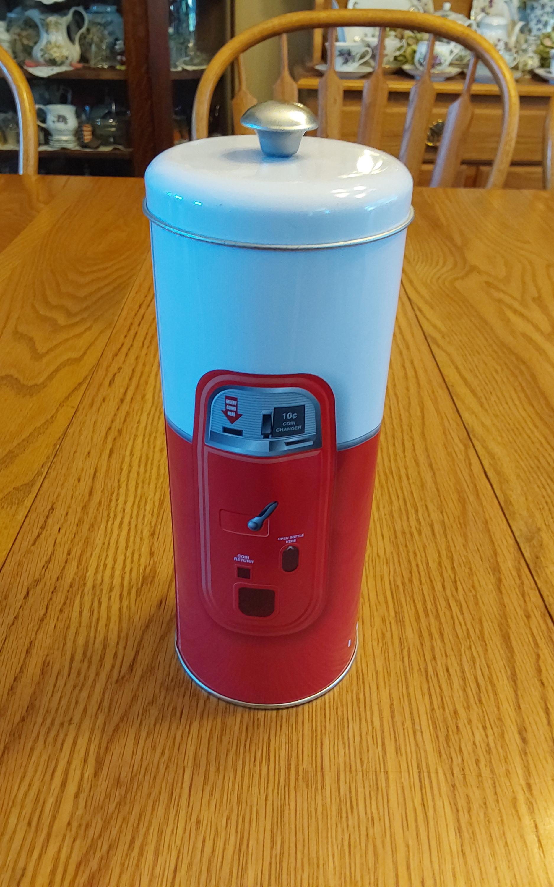 A Reproduction of a Metal White and Red Coca-cola Lidded Canister