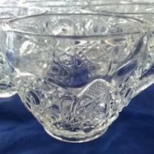 May include: Set of clear glass punch cups with a cut glass design. The cups are stacked on top of each other.