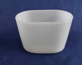 From the 1960s, this is an oval Vase-Mate white milk glass vase or planter with a flat bottom.  MG 533