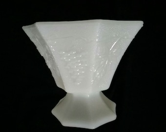 A octagon shaped dish of white milk glass on a pedestal...no lid.  Milk Glass 84