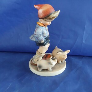 A vintage Farm Boy with Piglets-number 66, marked M J Hum on the top and "V" with a bee-W Germany blue backstamp 1960s. Misc 2051 image 2
