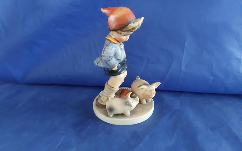A vintage Farm Boy with Piglets-number 66, marked M J Hum on the top and "V" with a bee-W Germany blue backstamp 1960s. Misc 2051 image 2