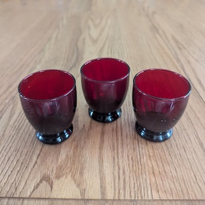 A trio of Anchor Hocking Royal Ruby Baltic pattern juice glasses. Glass 797
