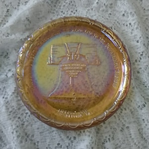 By Indiana Glass, a bicentennial commemorative Marigold Carnival glass 8 inch plate of the Liberty Bell with great iridescence.  Misc 1042