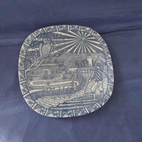 A white Danish Julen Rorstrans Sweden 7.5" square collector plate from 1977 with a blue scenic design.  Plate 795