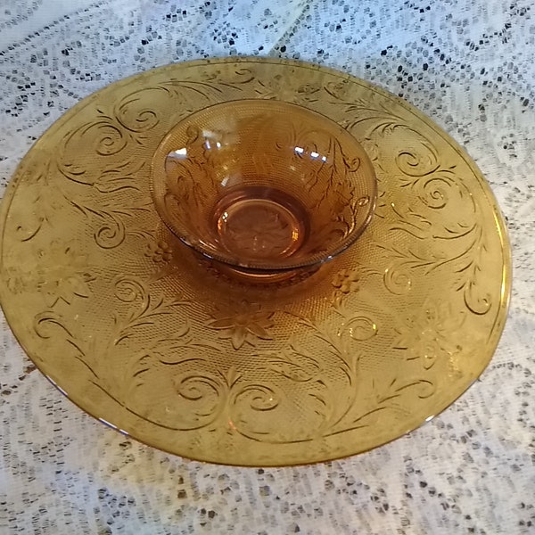 An amber gold Tiara patterned 13" footed tray with a recessed area for the matching dip bowl, by Indiana Glass.  Tiara 114