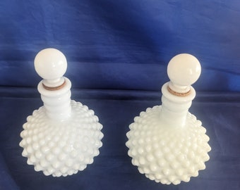 A pair of Vintage Fenton Milk Glass Hobnail Perfume bottles with stoppers.  avon c 142