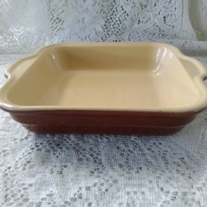An Emily Henry 8&quot; square brown stoneware with beige interior casserole dish with handles made in France.  CD 65