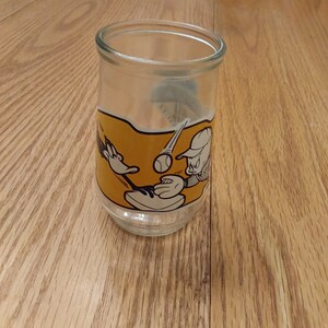A Loony Tunes 4th in a collector series of 12, that is an empty Welch&#39;s 8 oz jelly jar with Porky Pig and Daffy Duck.  Glass 676