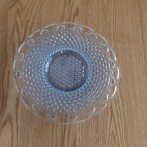 A 14" clear blue glass platter in the Katy pattern with an open lace rim that has a 5 inch recessed area in the center.  Plate 737