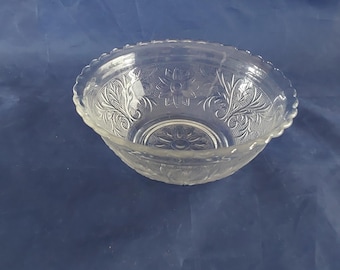 May include: A clear glass bowl with a scalloped rim and an etched floral design.