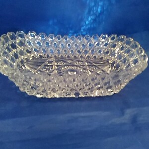 An EAPG rectangular shaped glass bowl with a hobstar and fan design and honeycomb hexagon block sides with a squared tooth rim.  Bowl 867