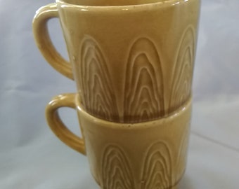 A set of 2 MCM gold ceramic handled 8 fluid ounce mugs from Japan that are stackable.  Glass 418